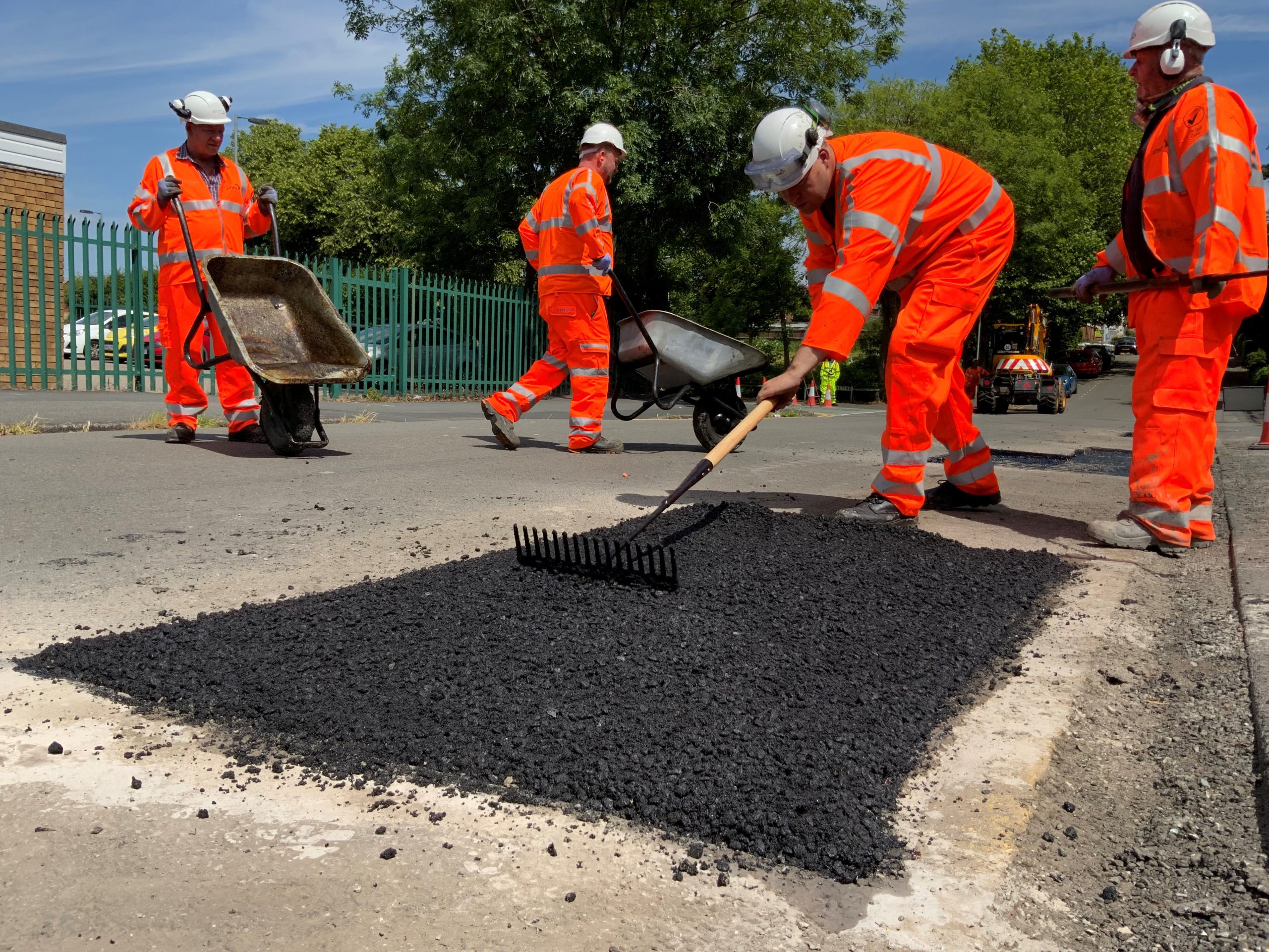 Highways wokers fixing pothole group